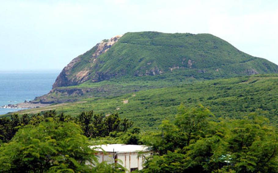 Mount Suribachi on Iwo Jima, the site of the famous flag-raising by U.S. Marines during World War II. A Joint POW/MIA Accounting Command team was on the island Wednesday looking for the remains of Marine Sgt. William H. Genaust, a combat photographer who filmed the famous second raising of the American flag on the island.