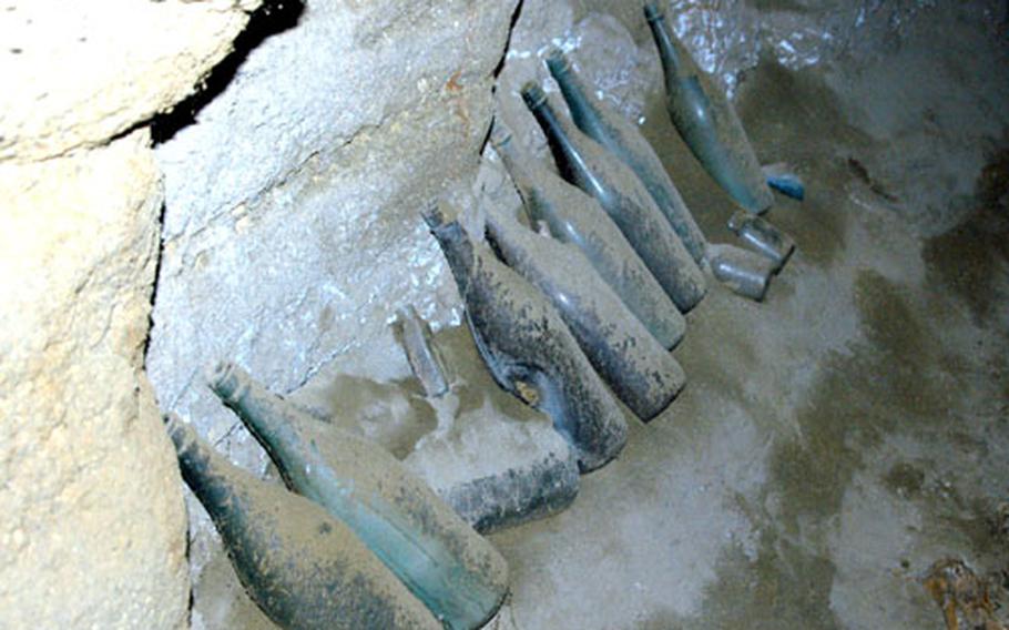 A row of Japanese glass bottles is seen inside a tunnel near Hill 362 A during a Joint POW/MIA Accounting Command site investigation on Iwo Jima.