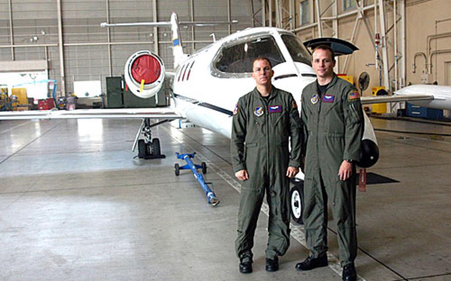 Capt. Chris Garnett (left) and 1st Lt. Mike Maughan, the crew of the last C-21 plane.