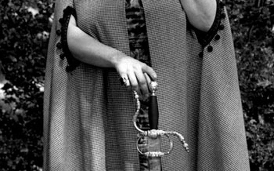 Sybil Leek poses with her ceremonial cape and sword.