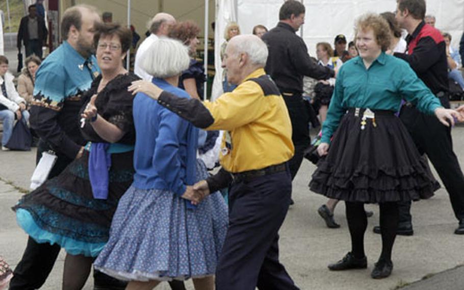 A German group of performers showcases their square dancing skills at the U.S. Army site, where American traditions were on display for Rheinland-Pfalz Days.