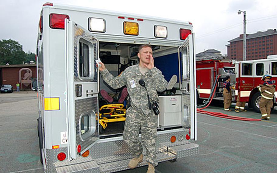 Maj. Jay Baker, 121st Combat Support Hospital, shouts instructions to medical personnel after loading a casualty onto an ambulance during a mass casualty exercise.