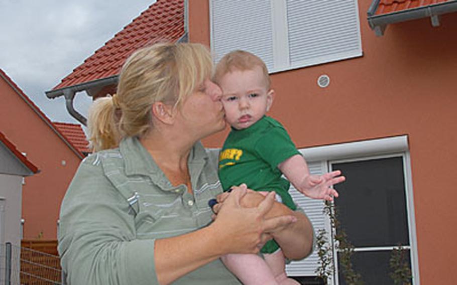 On Friday afternoon 2nd Cavalry (Stryker) Regiment spouse Tammy Williams kisses her son, Braden, 7 months old, at their new house in Netzaberg.