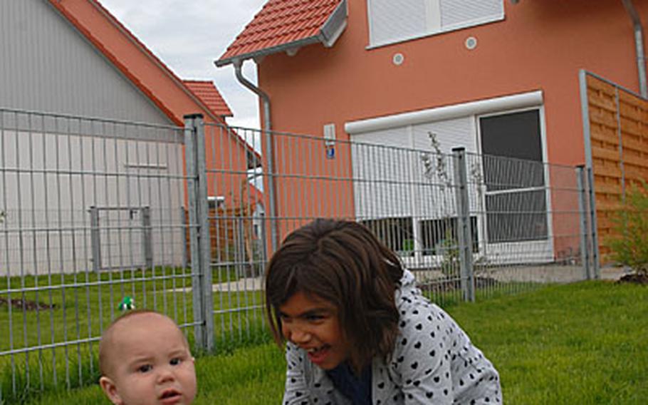 Grace Griffin, 8, plays with her younger brother, Brady, 7 months old, at their new house in Netzaberg.