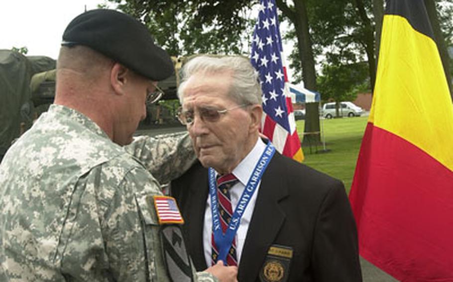 Maurice Sperandieu, a Belgian soldier who was attached to Gen. George S. Patton’s 3rd Army, was one of three Belgians who received the Outstanding Civilian Service Medal. He is one of the founders of the annual Bastogne Perimeter Walk, now in its 30th year. U.S. Army Col. Dean A. Nowowiejski, the U.S. Army Garrison Benelux commander, presented the award.