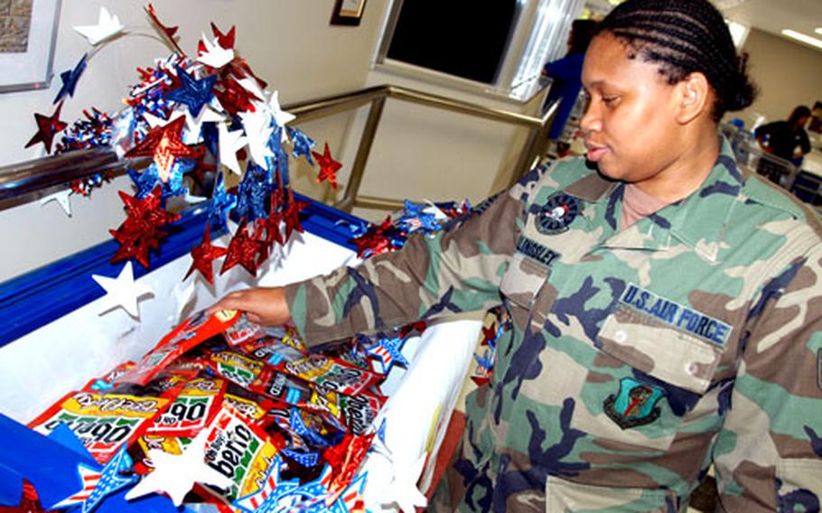 Staff Sgt. Gwenly Billingsley donates a bag of beef jerky to deployed airmen from Misawa Air Base, Japan, Monday. Customers could buy beef jerky at Misawa&#39;s commissary at a discount for troops downrange. The 35th Fighter Wing chapel is putting together care packages for the airmen.