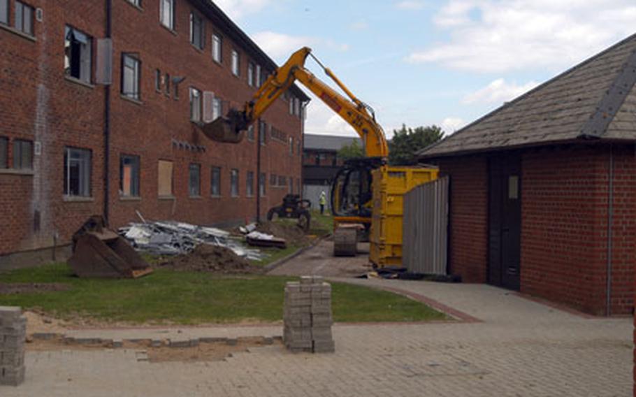 Demolition work began last week on Building No. 402 near the heart of RAF Mildenhall. The building is being razed as part of the base&#39;s long-term plan to construct new dormitories.