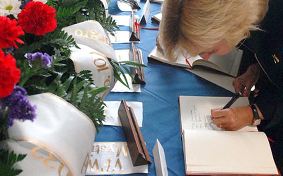 Mourners sign condolence books before the memorial ceremony for the five fallen soldiers.