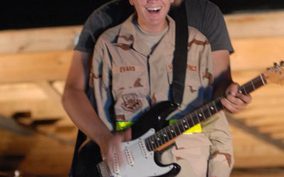 Air Force Tech. Sgt. Jennifer Evans, 35, of Kenosha, Wis., gets a taste of show biz when she was invited to perform with guitarist Mark Agnesi, 24, of Hollywood, Calif.