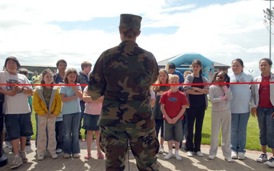 Maj. Tammy Hinkston prepares to cut the ribbon at the new Heritage Park playground and picnic area.