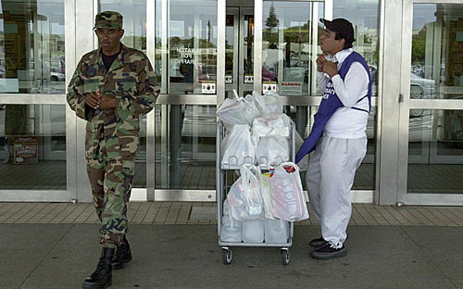 Staff Sgt. Demetric Byrd, left, was one of the many who flocked to Kadena Air Base&#39;s commissary to stock up on items like water and snacks in preparation for Typhoon Man-Yi&#39;s arrival on Okinawa.