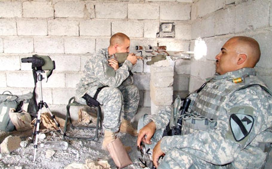 Sgt. Brion Baker, left, from Magdalena, N.M., ensures his sniper rifle is ready while Staff Sgt. Baltazar Vela takes a break after the men helped to establish a combat outpost in northern Iraq. The two are assigned to 5th Battalion, 82nd Field Artillery Regiment.