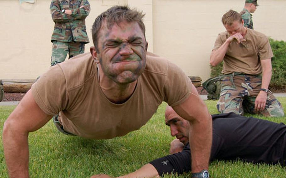 Staff Sgt. Matthew Zimmer pumps out as many push-ups as he can during the physical fitness portion of the Survival, Evasion, Resistance and Escape Challenge at Fairchild Air Force Base, Wash.