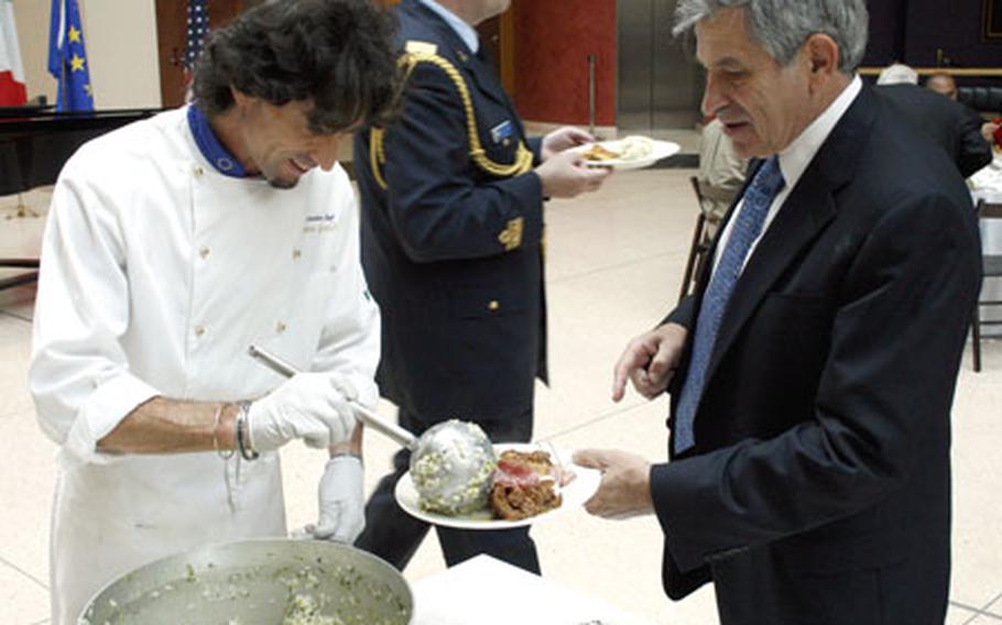 Roberto Grazioli, executive chef at the Italian Embassy in Washington, D.C., serves former Deputy Secretary of Defense Paul Wolfowitz at Friday&#39;s dinner for wounded servicemembers.