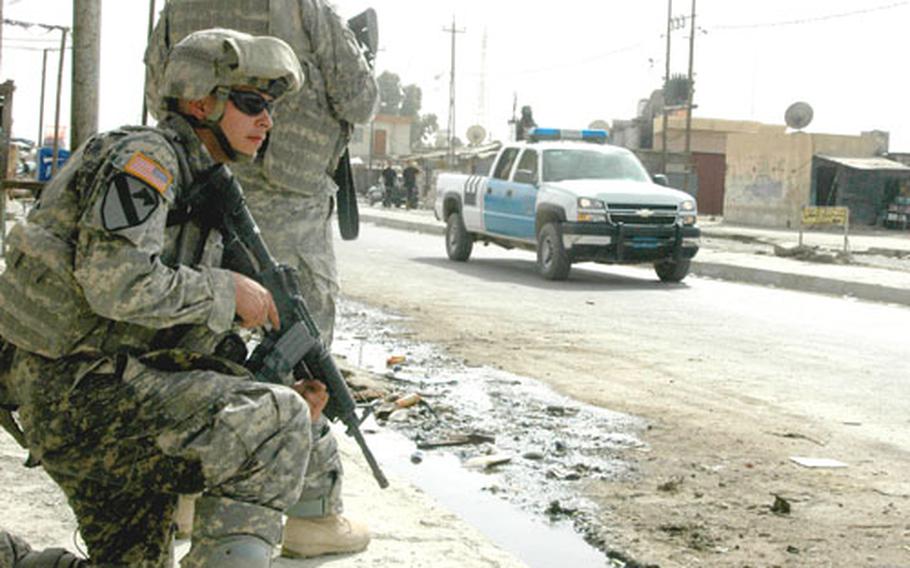 Spc. Steven Baugher, 20, of Kingston, Mich., kneels during a foot patrol in the northern Iraqi town of al Qayyarah.
