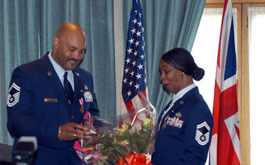 Senior Master Sgt. Jonathon Holbrook presents his wife with diamonds as a retirement gift during a ceremony to honor the Air Force couple who are retiring after 52 years of combined service.