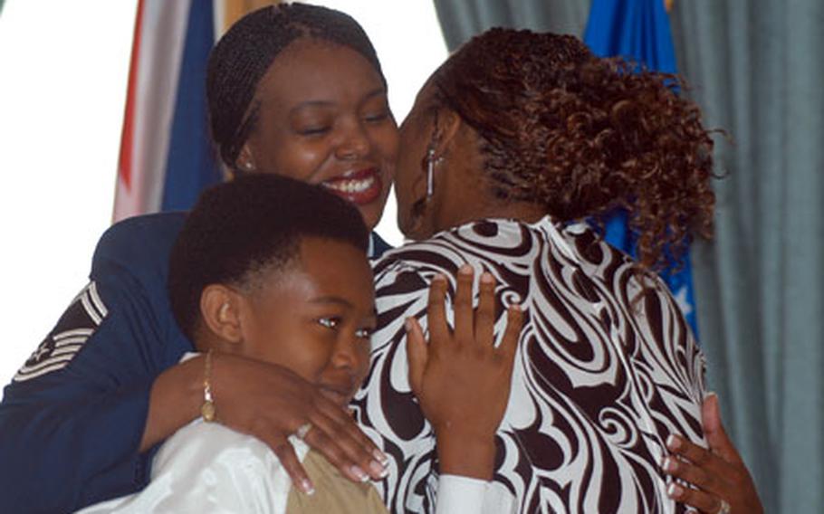 Senior Master Sgt. Carla Holbrook embraces her children, Joia, 19, and Christian, 11, during the retirement ceremony for she and her husand, Senior Master Sgt. Jonathon Holbrook.