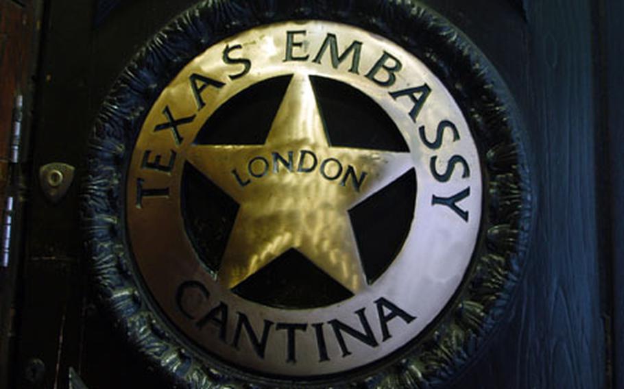 A shield for a sign welcomes guests to the Texas Embassy Cantina.
