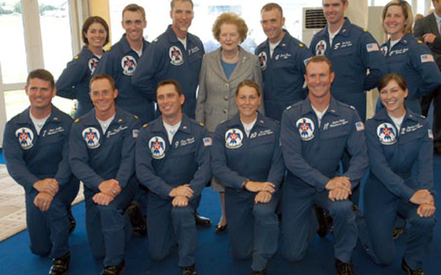 The U.S. Air Force Thunderbirds team poses for a photograph with former British Prime Minister Margaret Thatcher following the team&#39;s performance at the Royal International Air Tattoo on Saturday. Nearly 270 aircraft from 24 countries were slated to attend the annual air show at RAF Fairford.