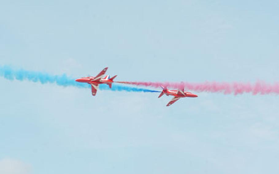Two Hawk jets from the Royal Air Force&#39;s aerobatic display team, Red Arrows, cross paths a little too close for comfort during the Royal International Air Tattoo. Nearly 270 aircraft from 24 countries were slated to attend the annual air show at RAF Fairford.