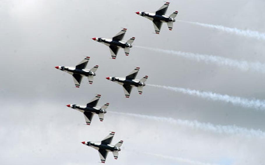 A formation of F-16C Fighting Falcon jets from the U.S. Air Force Thunderbirds team soar past a crowd gathered for the Royal International Air Show.