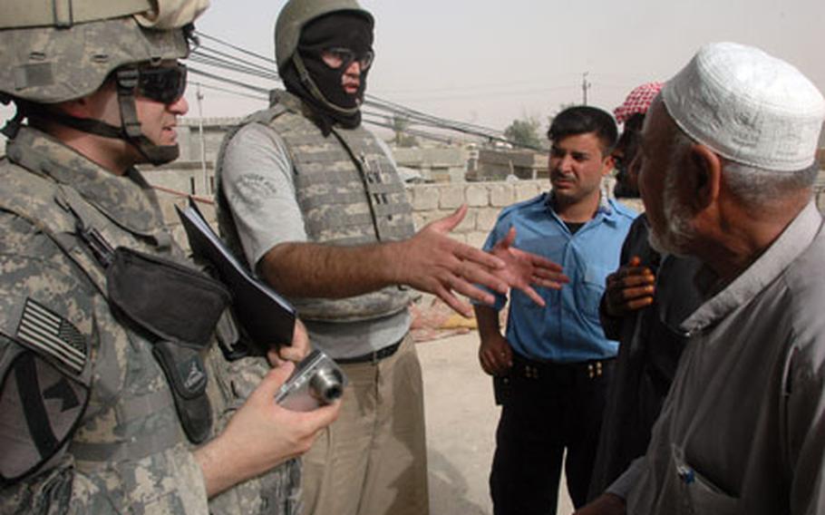 Second Lt. Seth E. Enterline, 23, of Warrenton, Va., (at left) helps lead an investigation team through several houses where civilian property was damaged during a raid in al Qayyarah, Iraq. The raid captured several high-value targets, officials said.