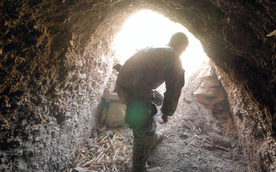 Sgt. Shane Nunes, 23, of Stockton, Calif., exits a mountain tunnel in Zabul Province, Afghanistan recently.
