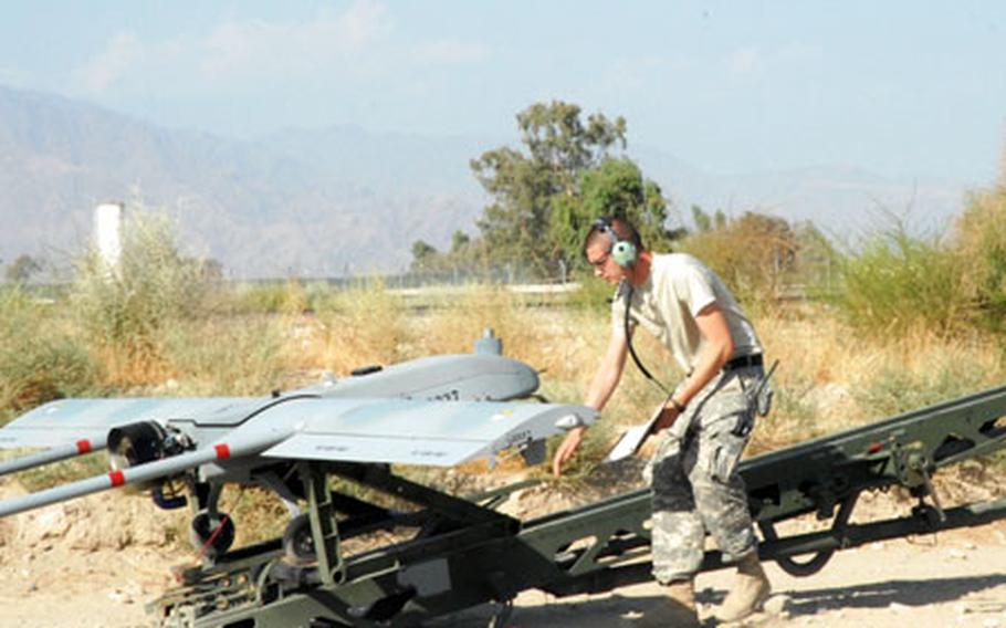 Sgt. Jeremy Squires, 26, from Wellsboro, Pa., checks a Shadow unmanned aerial vehicle shortly before launch Tuesday at Jalalabad Air Field, Afghanistan. Squires, a member of the 173rd Airborne Brigade Combat Team Special Troops Battalion&#39;s Tactical Unmanned Aerial Systems platoon, is deployed from Bamberg, Germany.