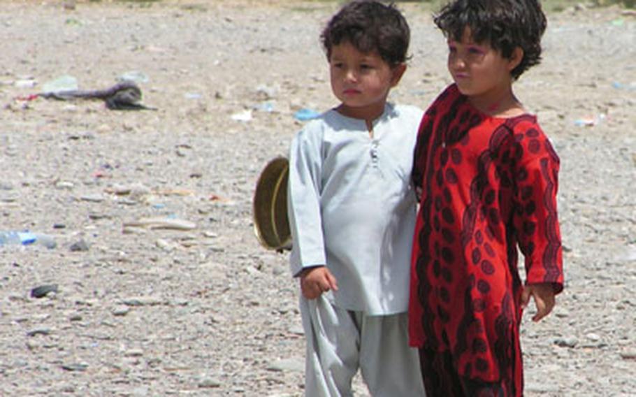 These children are among the locals outside Kandahar Airfield, Afghanistan, receiving donated clothes and other items.