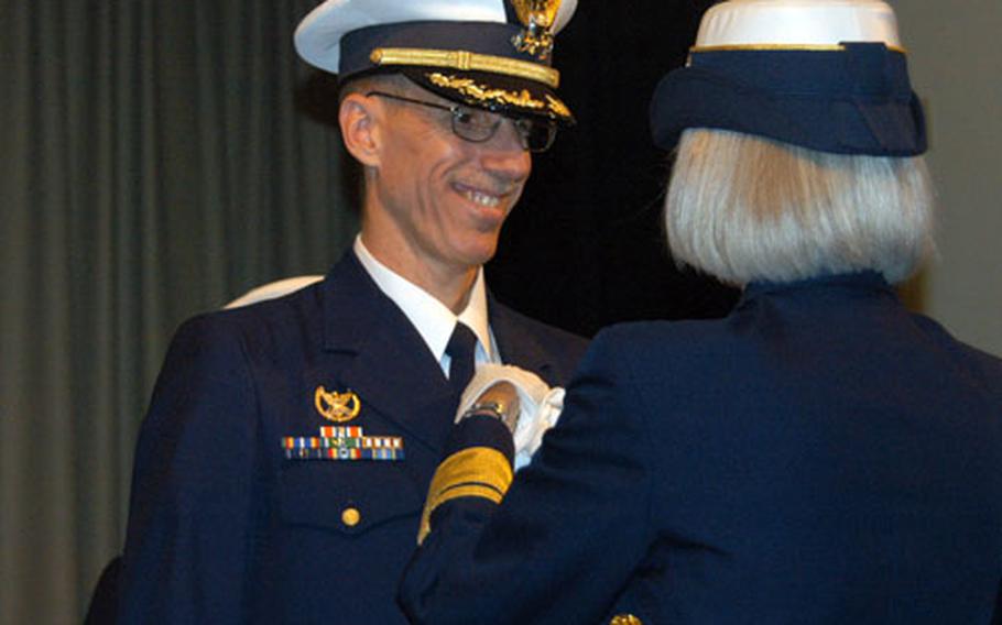 Capt. Michael L. Blair, the outgoing commander of the U.S. Coast Guard Activities Far East, receives the Meritorious Service Medal from Rear Adm. Sally Brice-O’Hara, commander of the 14th Coast Guard District, during a change of command ceremony.