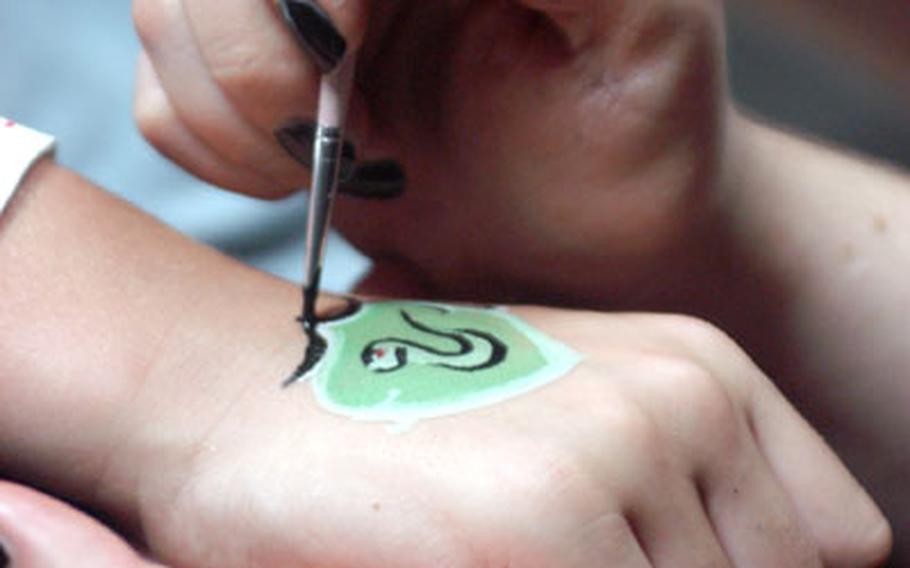 Among the activities held at the Army and Air Force Exchange Service BookMark in Wiesbaden, Germany, on Friday was decorative painting. One of the more popular requests was the crest of Slytherin, one of the four houses at Hogwarts School of Witchcraft and Wizardry featured in the Harry Potter books and movies.