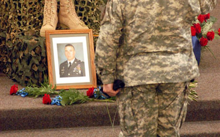 A 2nd Brigade, 1st Infantry Division soldier offers a final salute to Master Sgt. Jeffrey R. McKinney during a memorial service Wednesday in Schweinfurt, Germany.