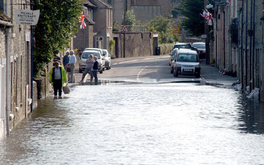 The A417 road, which cuts through Fairford&#39;s downtown, was still flooded on Tuesday.
