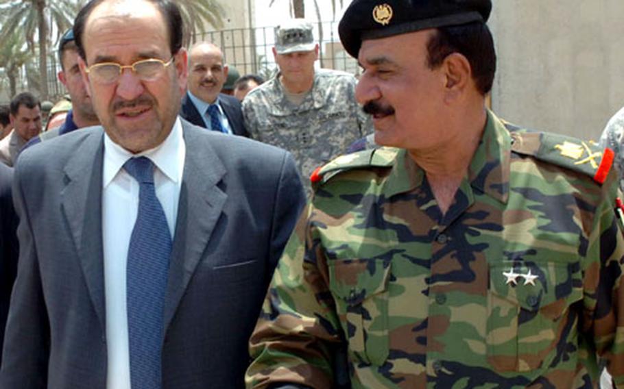 Iraqi Prime Minister Nouri al-Maliki walks with Staff Maj. Gen. Abdul Kareem, commander of Iraqi Security Forces in Diyala province, after arriving at the Baqouba Government Center on Thursday.