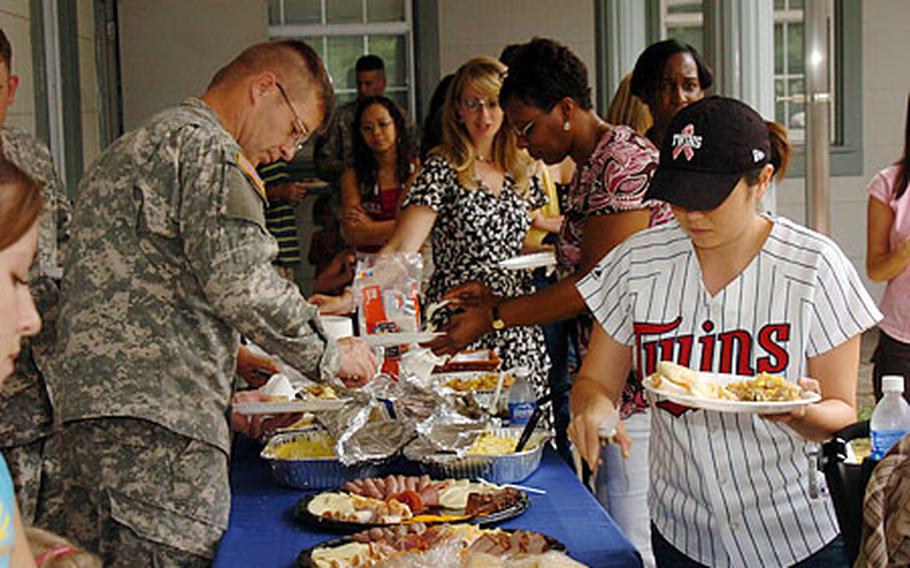 Soldiers and their families eat a buffet-style lunch at Camp Zama’s chapel Friday after a slideshow and ceremony celebrating the Chaplain Corps’ 232nd anniversary, which is Sunday.