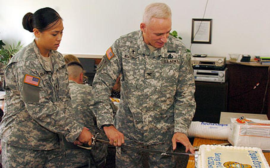 Col. Allen Blake Boatright, and Spc. Jennifer Villagomez cut a cake in Camp Zama’s chapel Friday after a slideshow and ceremony celebrating the Chaplain Corps’ 232nd anniversary.
