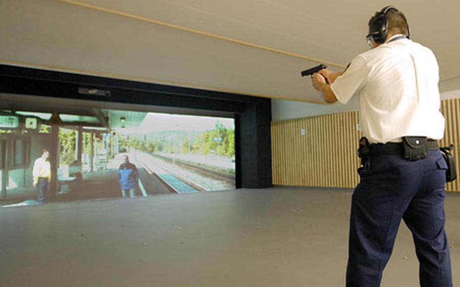 Francesco Mastroianni, a Pond security guard site instructor, practices shooting a 9 mm handgun in the new Pond Academy for Safety and Security in Erlensee, Germany.