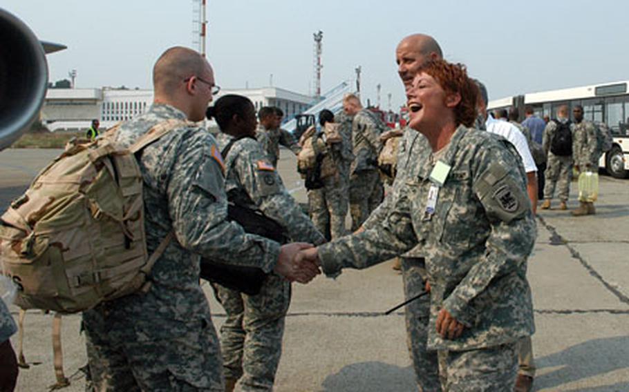 Army Sgt. Maj. Karen Kelly, right foreground, and Joint Task Force-East commander Col. Peri Anest welcome soldiers arriving at Romania&#39;s Mihail Kogalniceanu Air Base on Wednesday. The soldiers are part of a contingent that is laying the logistical groundwork for exercises in the coming months. Eventually, Romanian bases will host rotations for brigade exercises. The operation is being run by the Southern European Task Force, out of Vicenza, Italy.