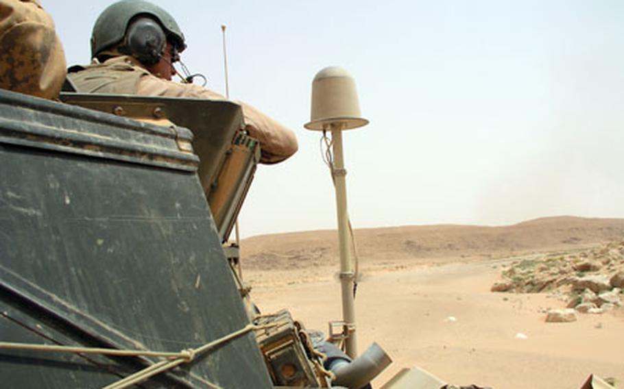 In a remote desert canyon northeast of Rutbah, Iraq, Friday, a U.S. Marine Corps armored vehicle scouts the area to check reports that oil pirates may been using it as an operating base.