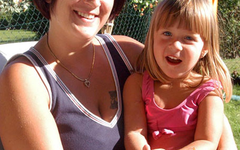 Ivonne Byerley, wife of Staff Sgt. Trent Byerley of Company A, 1st Battalion, 26th Infantry Regiment, in Schweinfurt, Germany, relaxes with their 3-year-old daughter, Alisha. Ivonne Byerley said she does not go to family readiness group meetings. Byerley speaks by phone often with her husband, who is based in Baghdad, and he provides all the information she needs.