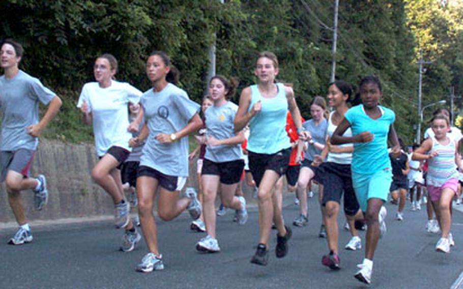 Kanto Plain Running Camp participants warm up Wednesday at the Tama Hills Recreation Area in Tokyo.