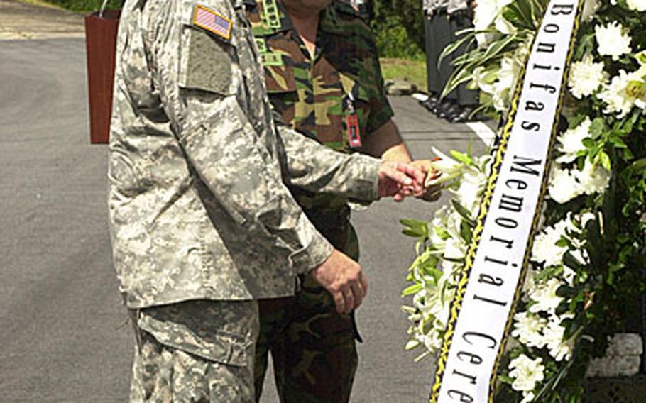 An American and a South Korean soldier pay their respects at the memorial for Army Capt. Arthur Bonifas and 1st. Lt. Mark Barrett, both murdered by axe-wielding North Korean soldiers during a tree trimming operation in 1976.