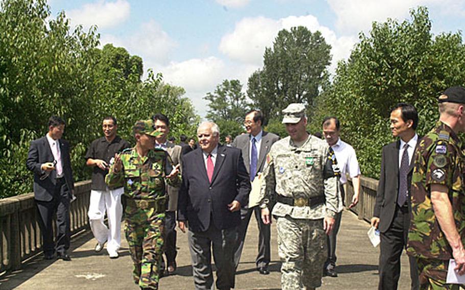 Vierra, center, walks with a South Korean officeer and current UNCSB commander Lt. Col. Mike Anastasia, left, on Friday at the Bridge of No Return. Vierra memorialized his soldiers, Capt. Arthur Bonifas and 1st Lt. Mark Barrett.