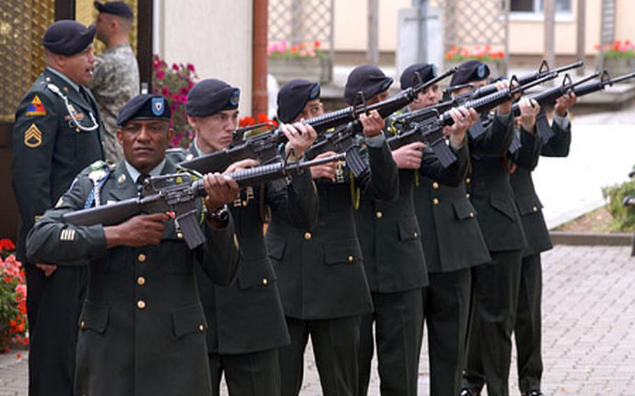 The honor guard fire volleys at the conclusion of the memorial service for Spc. Christopher Neiberger, at Ledward Barracks in Schweinfurt, Germany, on Wednesday.