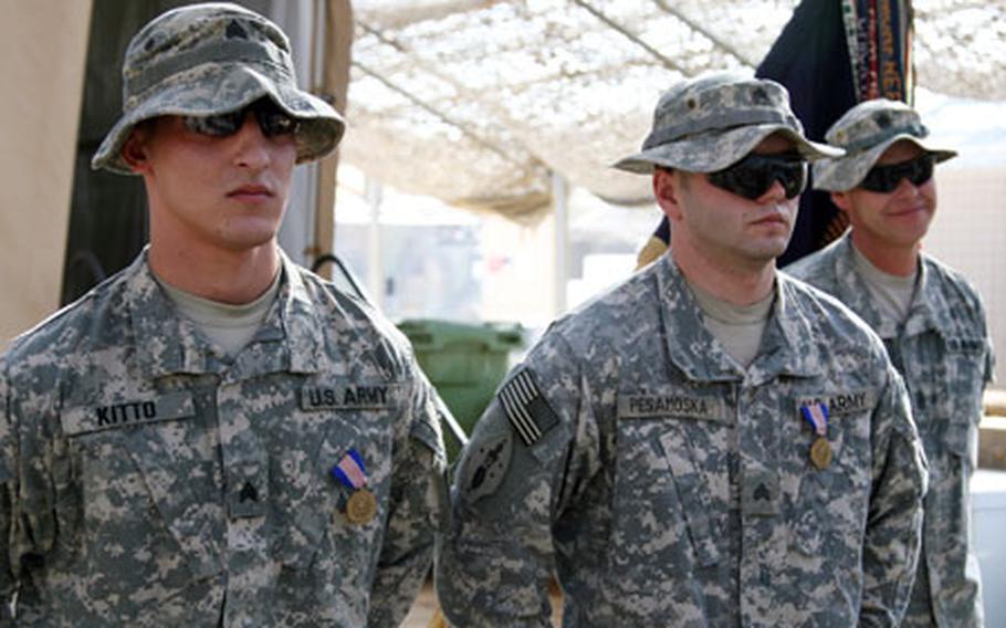 Sgt. Christofer M. Kitto, 23, of Altamont, N.Y., and Sgt. Michael C. Pesamoska, 25, of Lake Orion, Mich., stand at parade rest after receiving the Soldier&#39;s Medal from Lt. Gen. Raymond C. Ordierno during a ceremony Wednesday at Combat Outpost Cleary, south of Baghdad. The two sergeants received the medal, the Army&#39;s highest non-combat award, after saving the lives of three soldiers after their Humvee flipped over into a water-filled canal during a night patrol in April 2007.