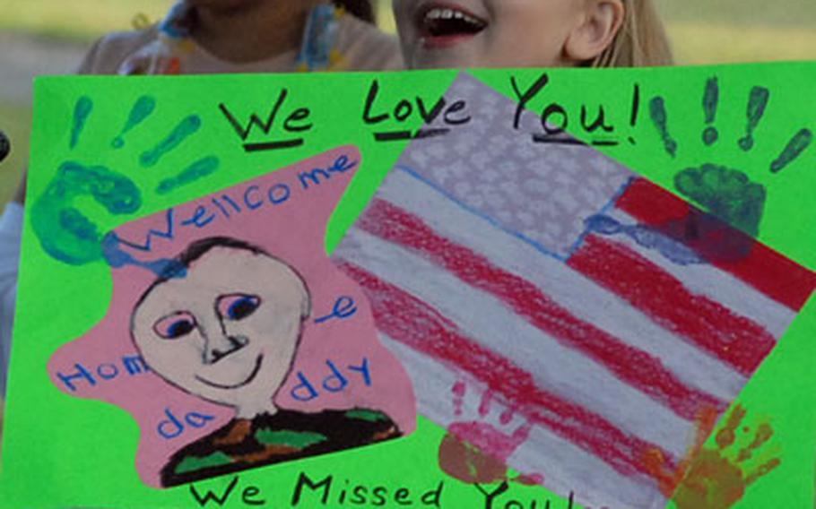 Makayla Simonds, 9, reacts as buses carrying her dad, Sgt. Phil Simonds, and about 200 other soldiers of the 596th Maintenance Company arrive at Kelley Barracks in Darmstadt, Germany, on Thursday evening. The soldiers were returning from a deployment to Iraq. She was there to meet dad with her mom, Barb and little brother, Tyler.