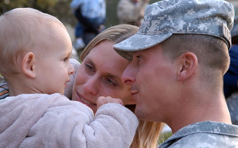 Eightteen-month-old Niklas Tychnowitz gets a good look at dad, Stephen, after the staff sergeant and about 200 other soldiers of the 596th Maintenance Company returned to Kelley Barracks in Darmstadt, Germany, from their Iraq deployment on Thursday evening. Mom Nadine was there with Niklas to meet Dad.