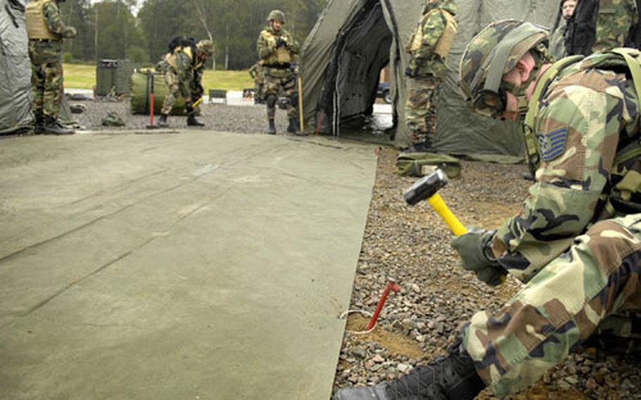 Air Force Tech. Sgt. Drew Hallead, a Security Forces craftsman from the 86th Contingency Response Group, stakes down the flooring of a DRASH. The 86th CRG is the Air Force’s "first-in" team designed to secure a bare-bones air field and establish operations. During the last year the unit deployed to 69 countries.