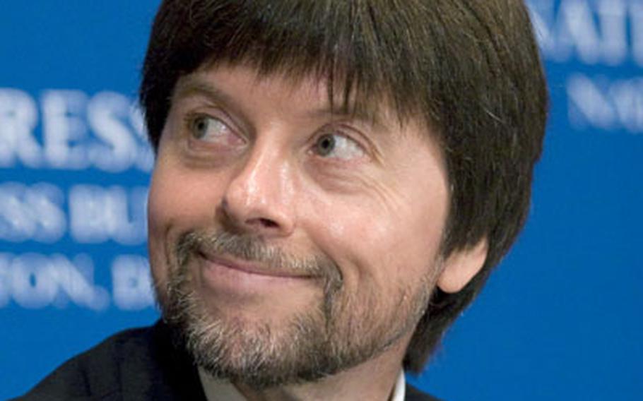 Filmmaker Ken Burns listens as head-table guests are introduced prior to his speech at the national Press Club in washington on Wednesday. Burns&#39; World War II documentary, "The War," begins on PBS this weekend.