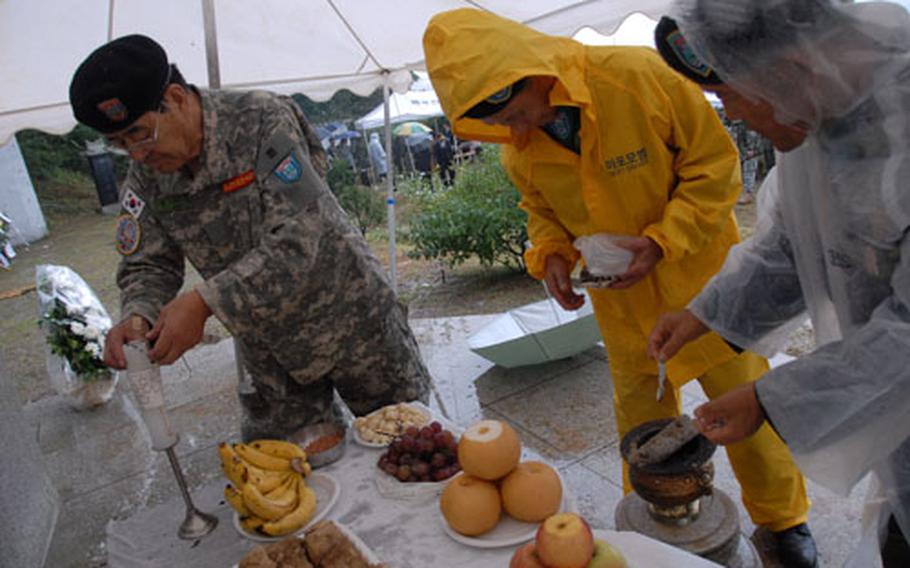 South Koreans set a table to honor guerilla fighters who died fighting against North Korea during the Korean War. Some Asians honor the dead by setting tables with food, laying flowers and lighting incense.